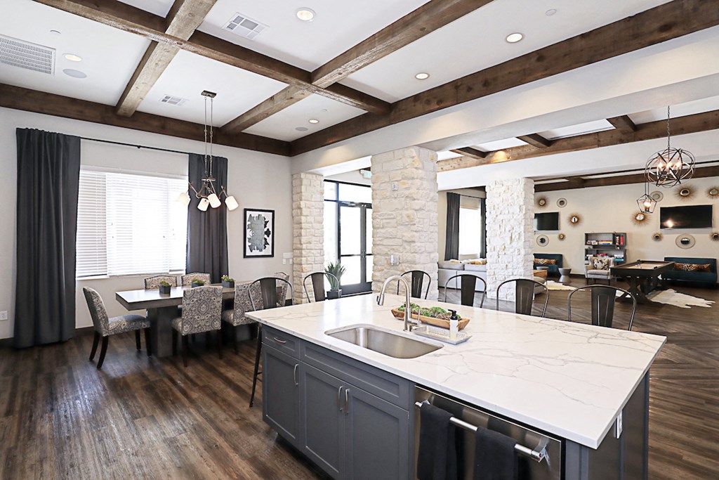 a kitchen with a large island and a dining room
