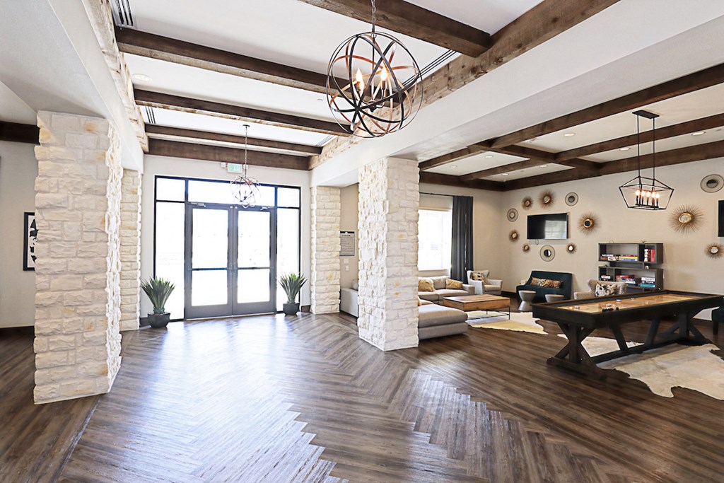 a large living room with a large glass door and a pool table