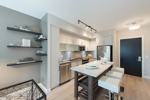 A modern kitchen with a dining table and chairs.