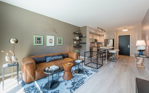 A living room with a brown leather couch and a coffee table.