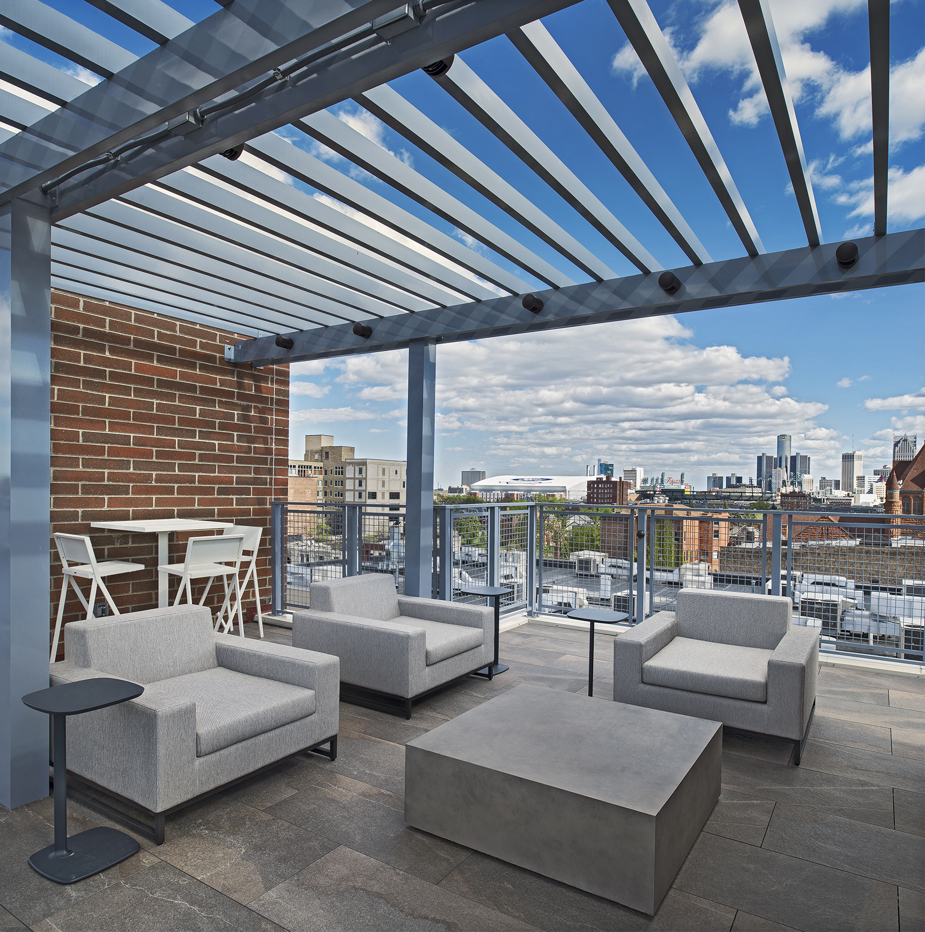 a terrace with couches and chairs and a view of the city