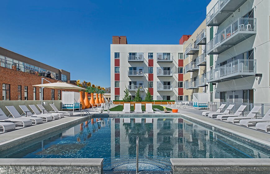 a swimming pool in front of a building
