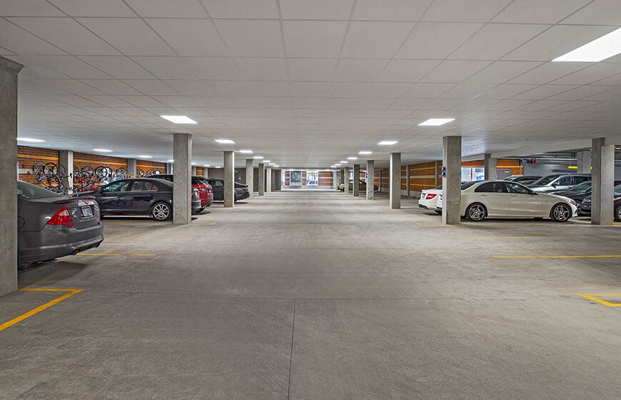 an empty parking garage with cars in it