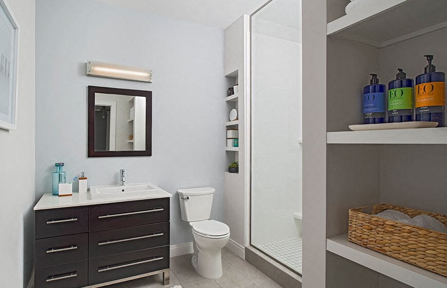 a bathroom with a toilet sink and a mirror