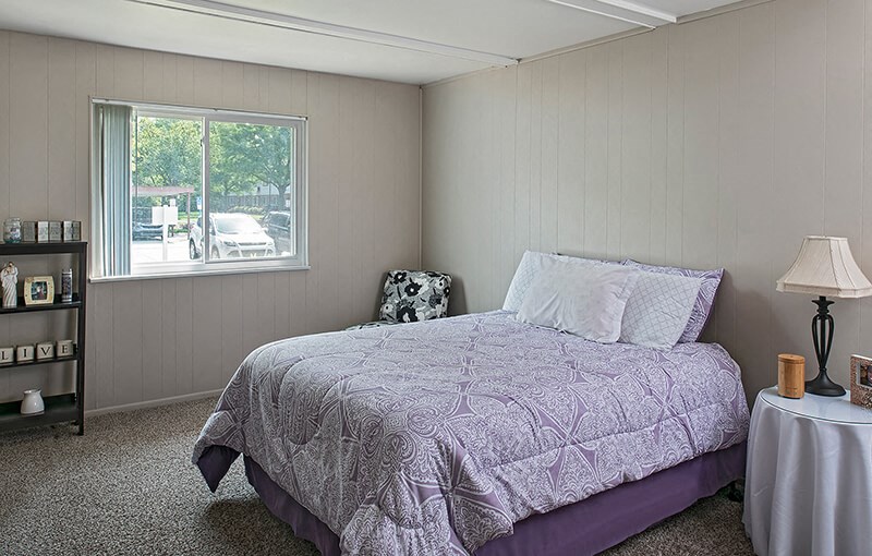 a bedroom with a bed and a window