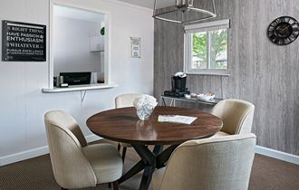 a dining room with a table and chairs