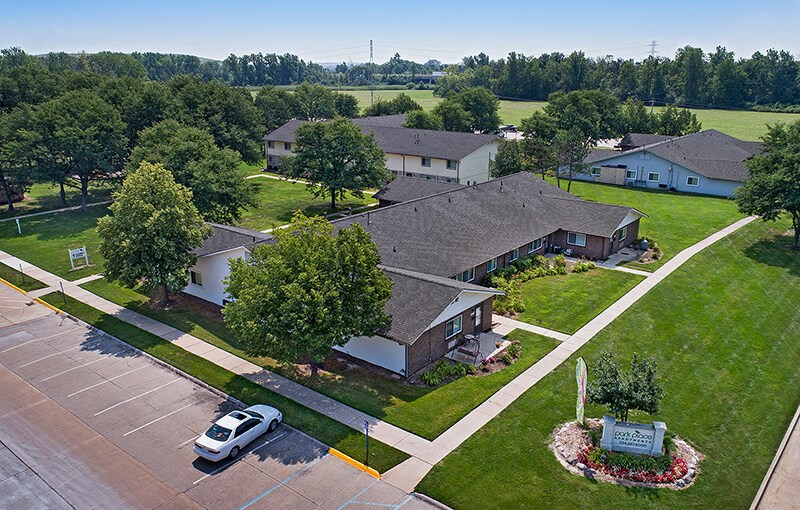 an aerial view of a neighborhood of houses with a car parked in a parking lot