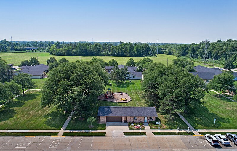 an aerial view of a neighborhood with houses and a field