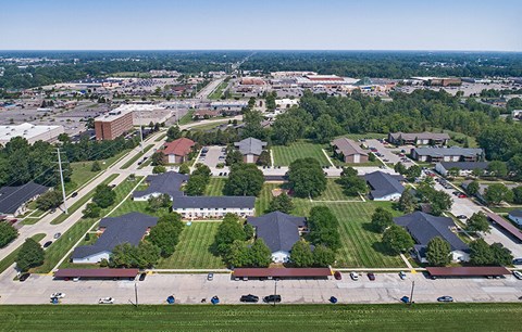 an aerial view of a suburb of a city with houses and a field