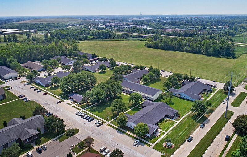 an aerial view of a neighborhood with houses and a field