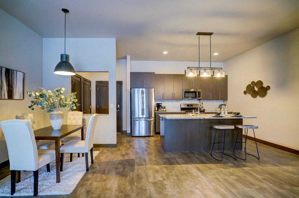 a kitchen and dining room with a table and chairs