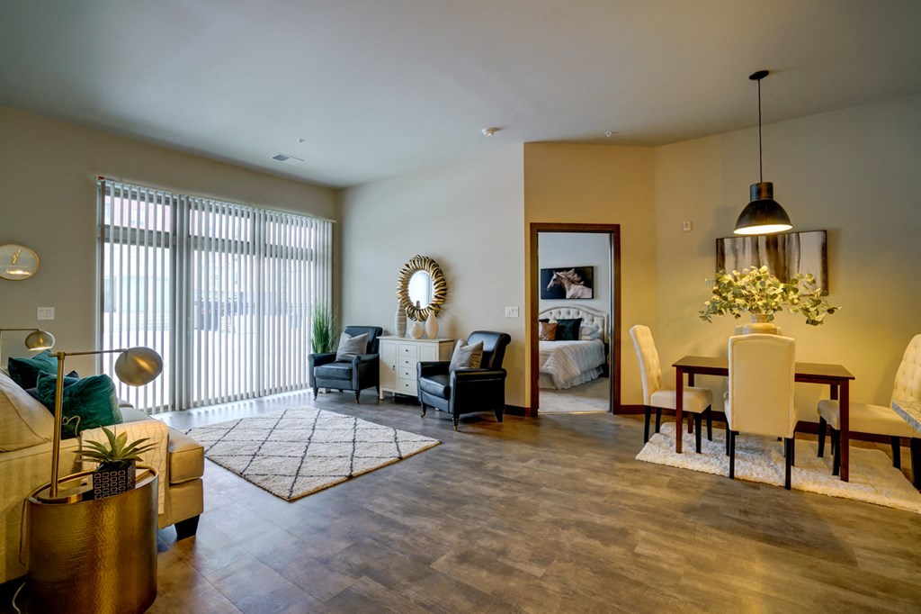 a living room and dining room with a table and chairs