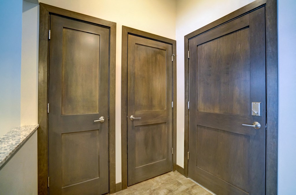 a pair of tall wooden doors in a hallway