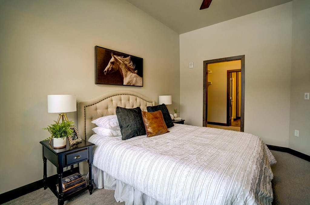 a bedroom with a bed and a mirror