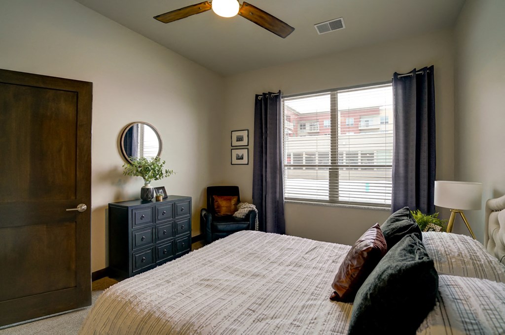 a bedroom with a large bed and a window