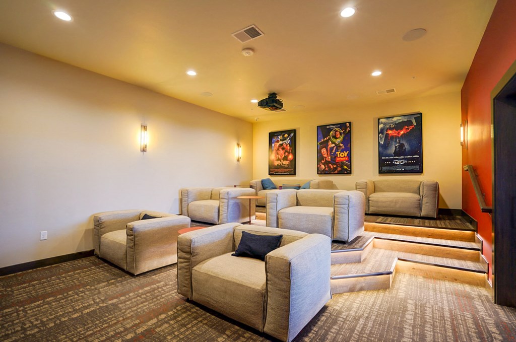 a large screening room with couches and chairs