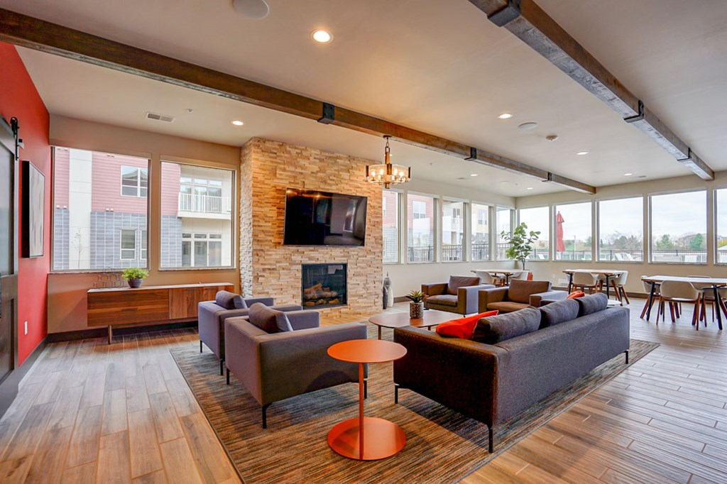 a living room with couches and chairs and a fireplace