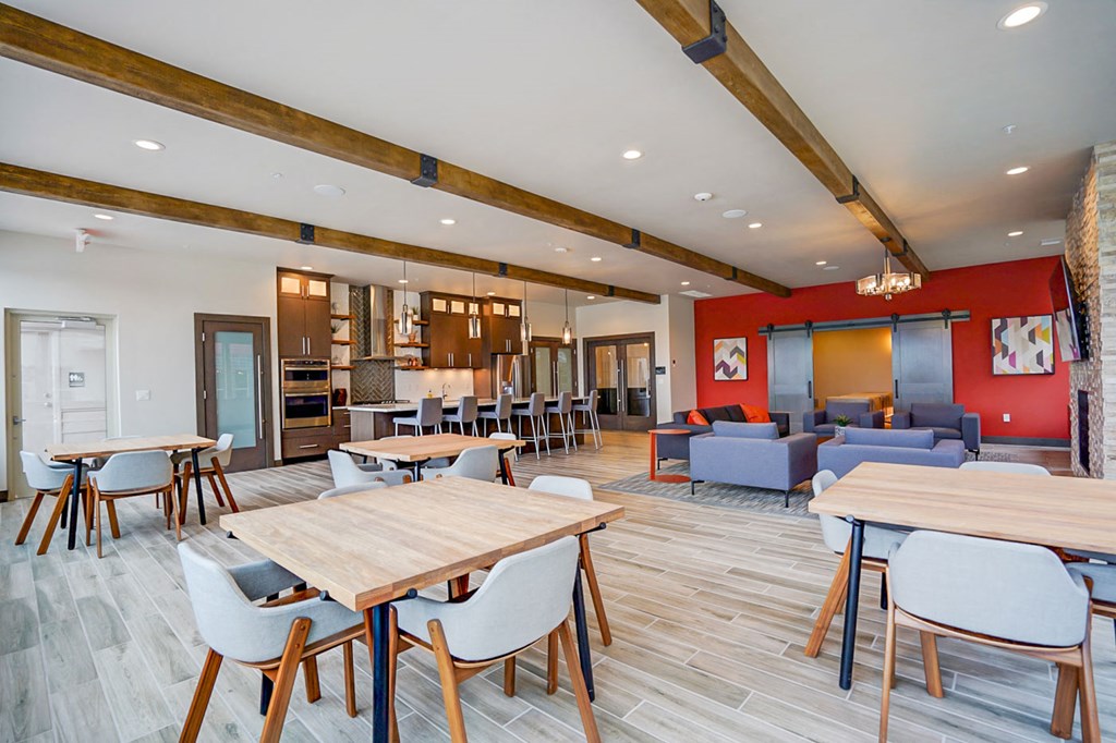 a dining room with tables and chairs and a living room
