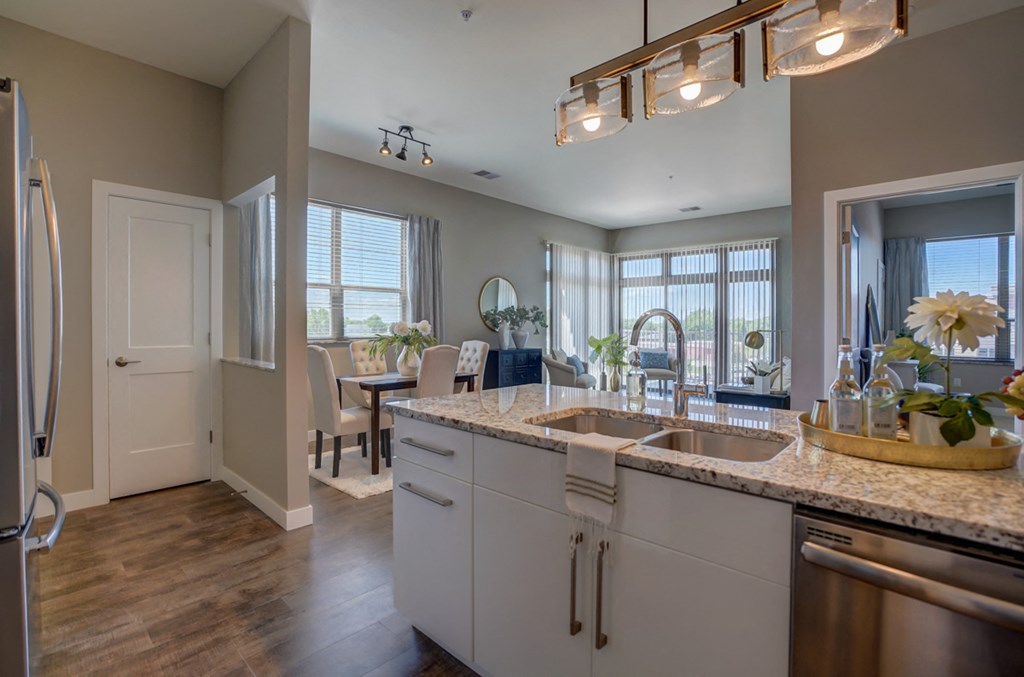 a kitchen and dining room with a sink and a window