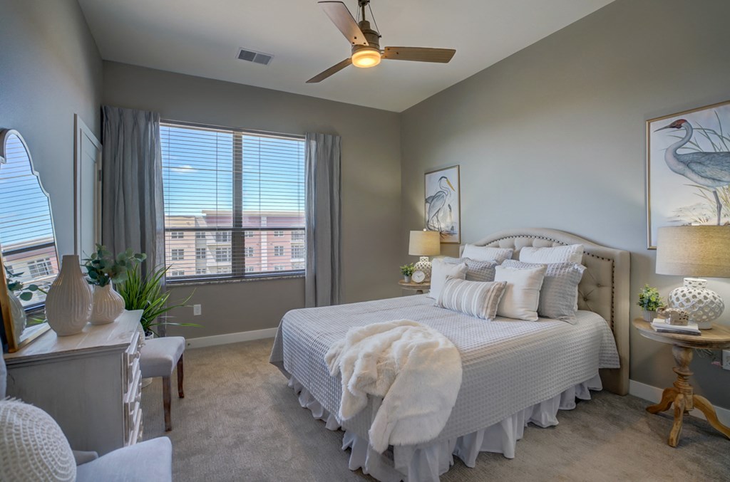 a bedroom with a large bed and a ceiling fan