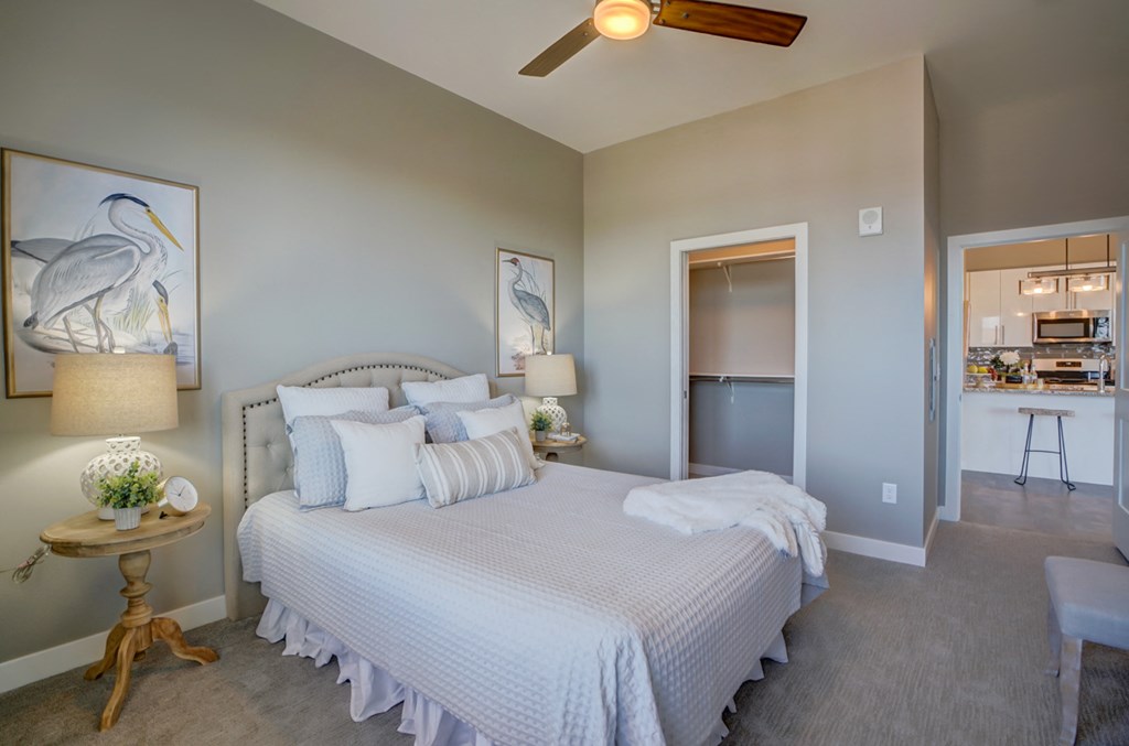 a bedroom with a large bed and a ceiling fan