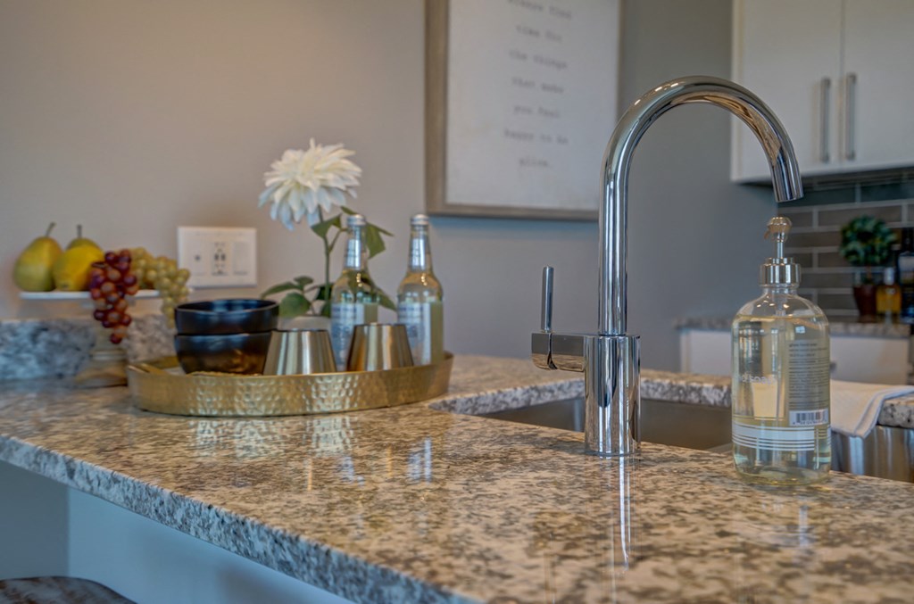 a marble counter top in a kitchen with a sink