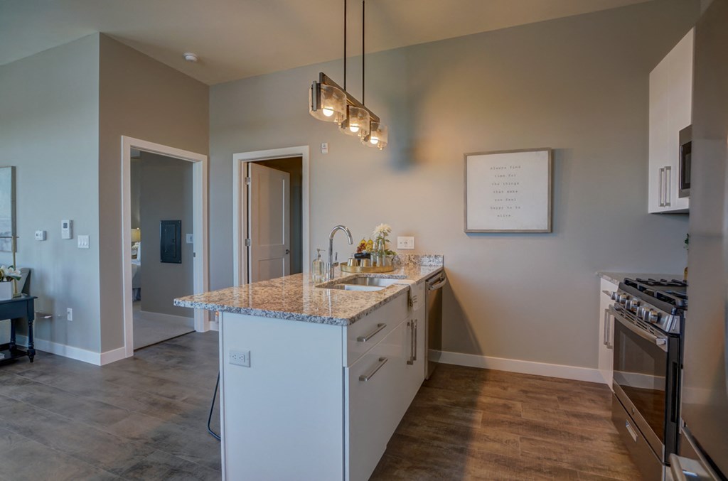 an empty kitchen with a sink and a counter top