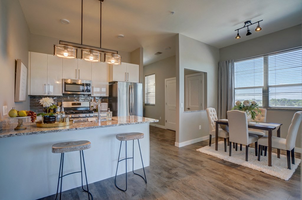 an open kitchen and dining room with a table and chairs