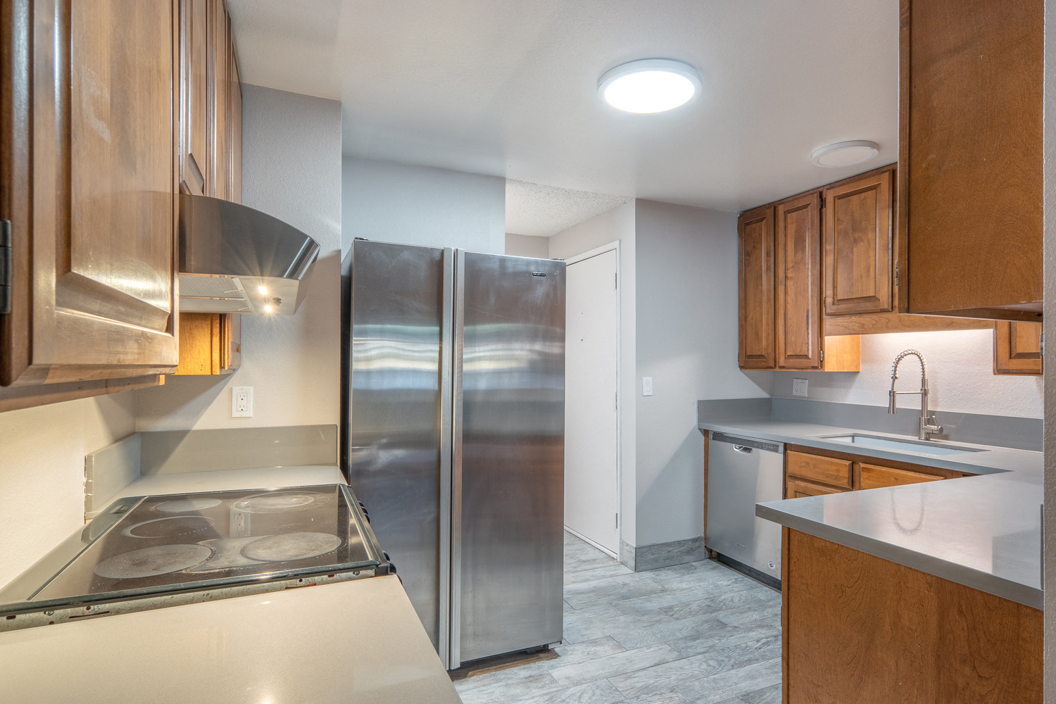 a kitchen with stainless steel appliances and wooden cabinets