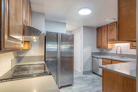 a kitchen with stainless steel appliances and wooden cabinets