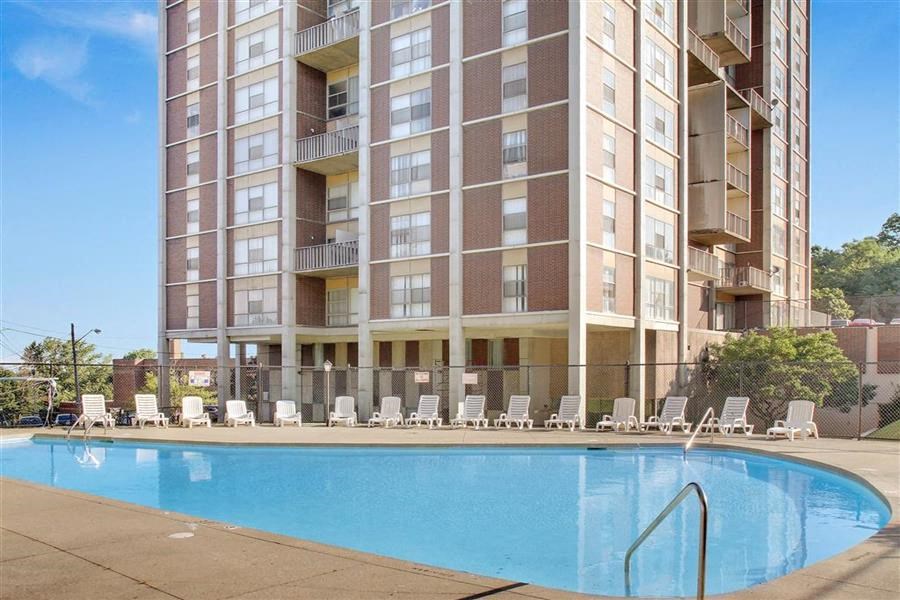 a swimming pool in front of an apartment building