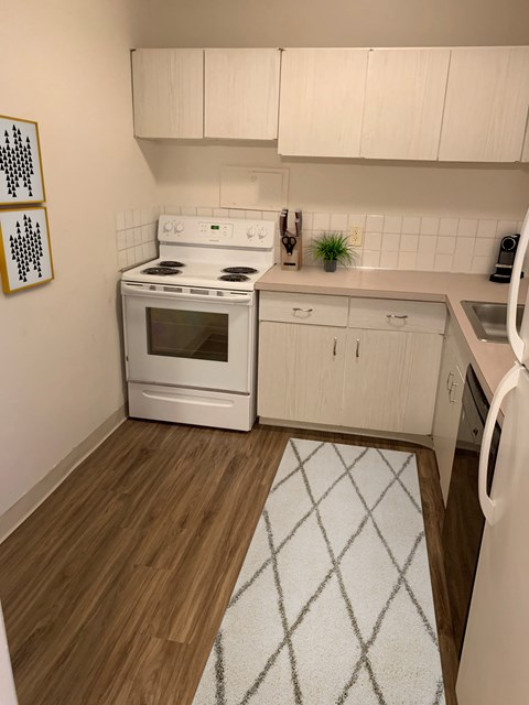 a kitchen with white appliances and white cabinets