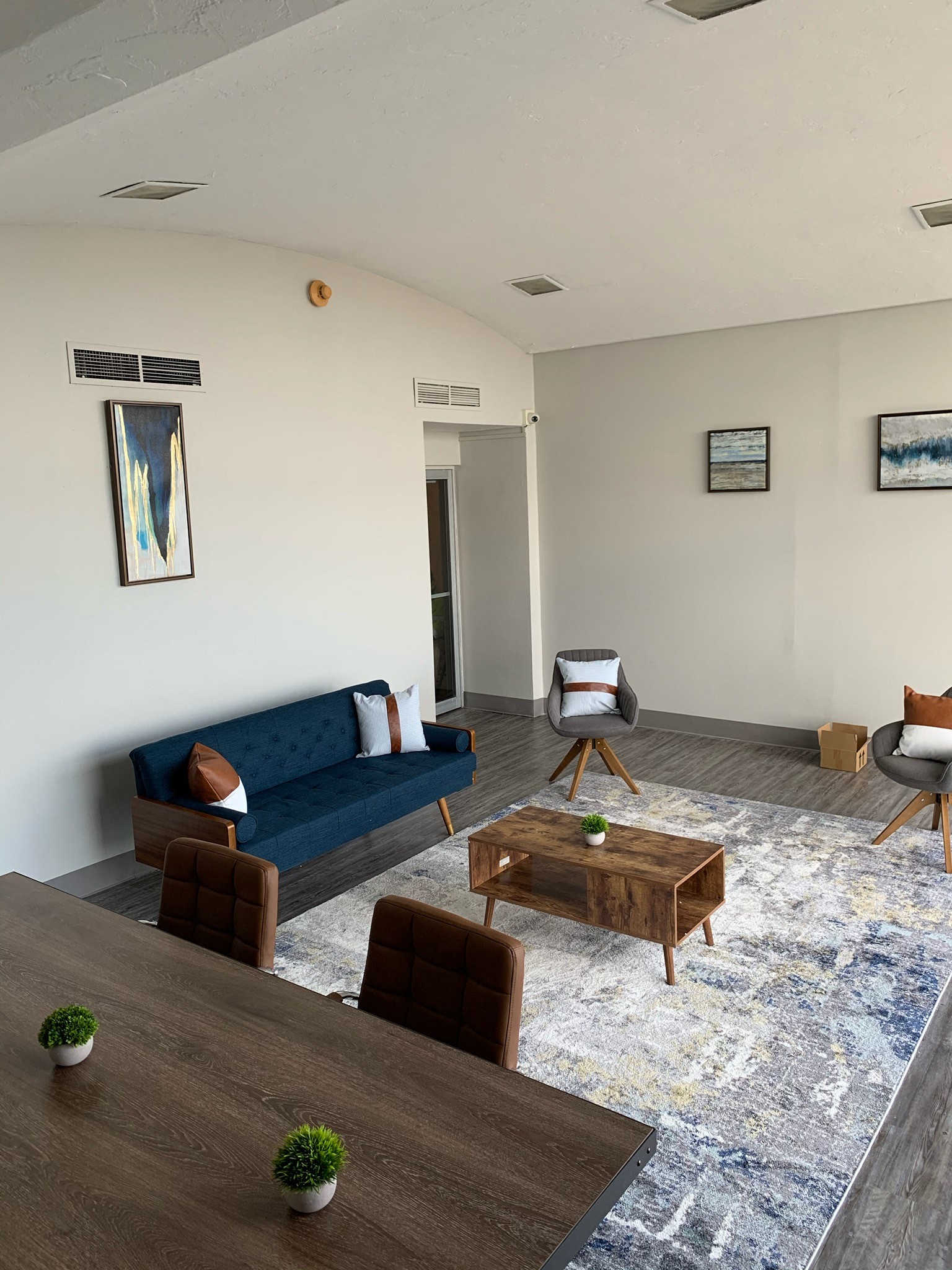 a living room with a couch and chairs and a table