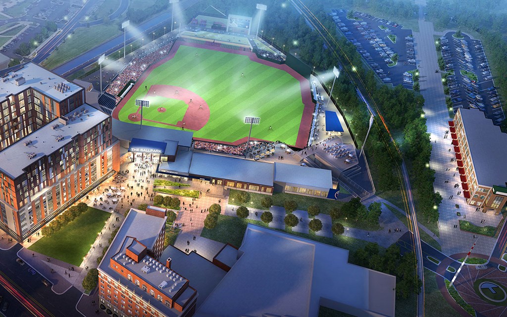 an aerial view of a baseball stadium and a city at night