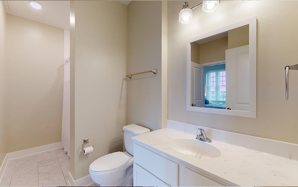 a bathroom with a sink toilet and a mirror