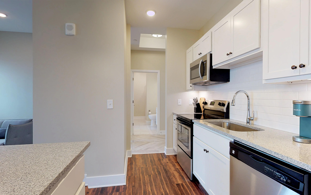 a kitchen with a sink and a stove and a microwave