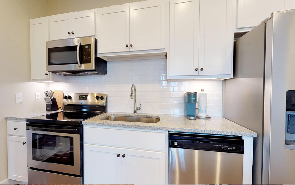 a kitchen with stainless steel appliances and white cabinets