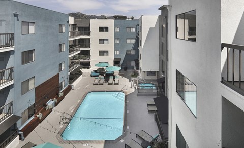 a view of the pool from the balcony of a hotel