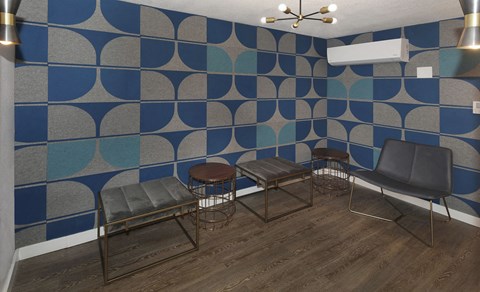 a group of chairs in a room with a blue and white wall