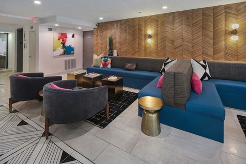 a living room with blue couches and chairs