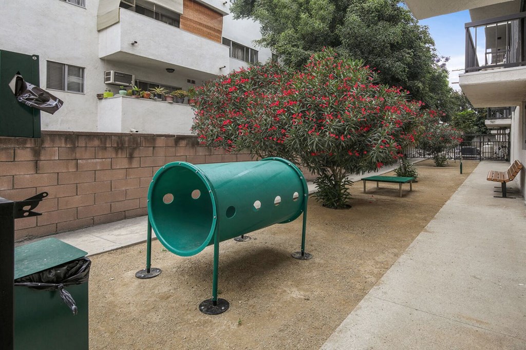 a green mailbox in front of an apartment building
