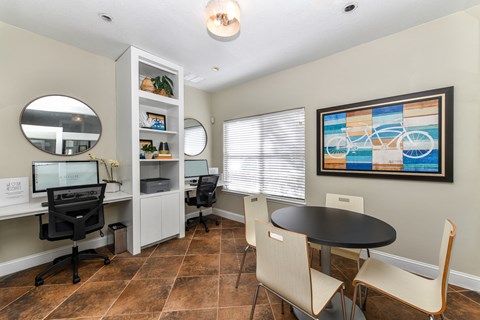 an office with a table and chairs and a window