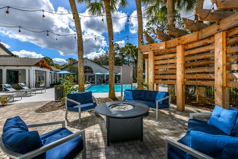 a patio with chairs and a table and a swimming pool