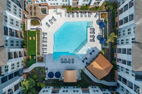 a view of the pool from the top of an apartment building