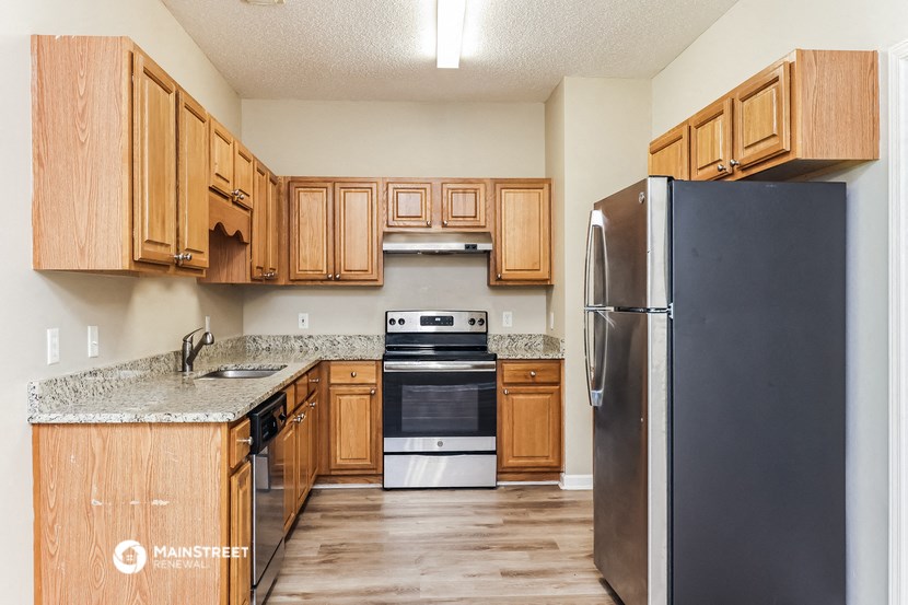 a kitchen with wooden cabinets and stainless steel appliances
