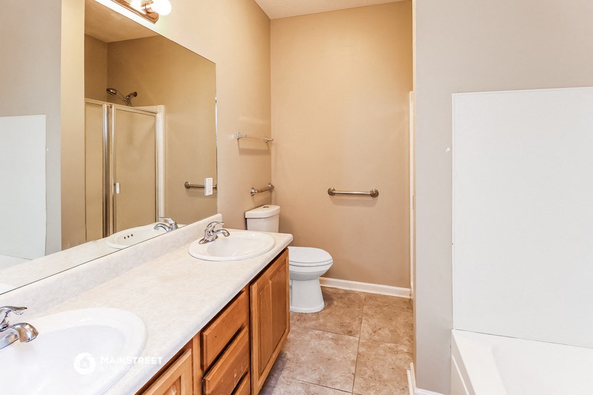 a bathroom with a toilet and a sink and a mirror
