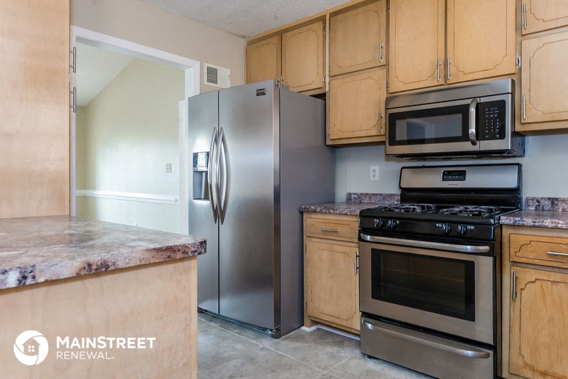 a kitchen with stainless steel appliances and wooden cabinets