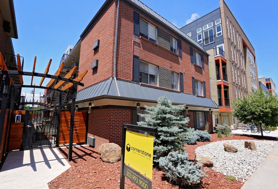 a brick building with a yellow sign in front of it