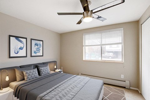 a bedroom with a large bed and a ceiling fan