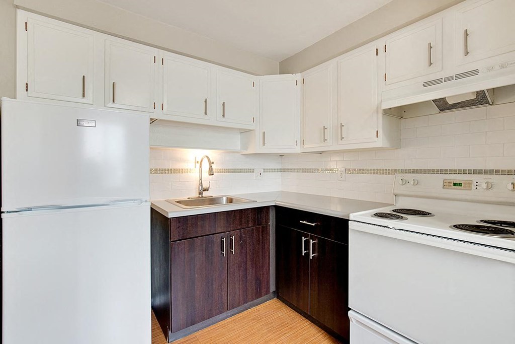 a kitchen with white appliances and white cabinets